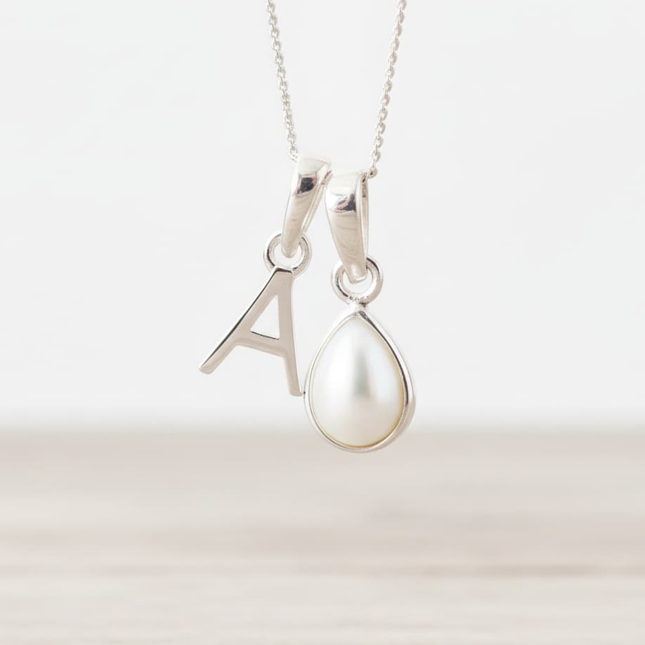 Sterling Silver June birthstone necklace with a pear-shaped natural mother of pearl pendant and letter 'A' charm.