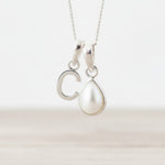 Sterling Silver June birthstone necklace with a pear-shaped natural mother of pearl pendant and letter 'C' charm.