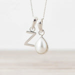 Sterling Silver June birthstone necklace with a pear-shaped natural mother of pearl pendant and letter 'Z' charm.