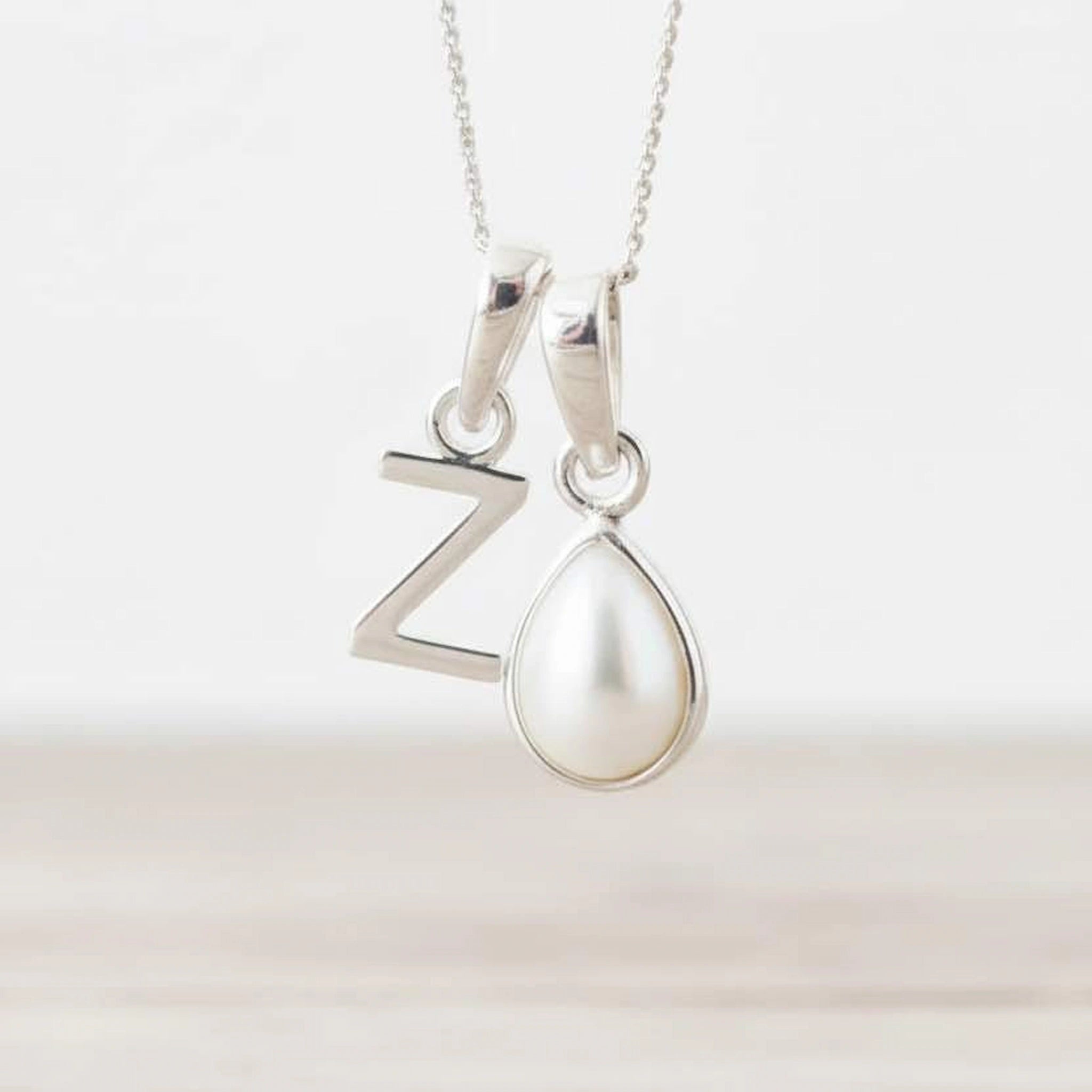Sterling Silver June birthstone necklace with a pear-shaped natural mother of pearl pendant and letter 'Z' charm.