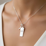 sterling silver initial necklace with libra zodiac pendant and initial pendant being worn