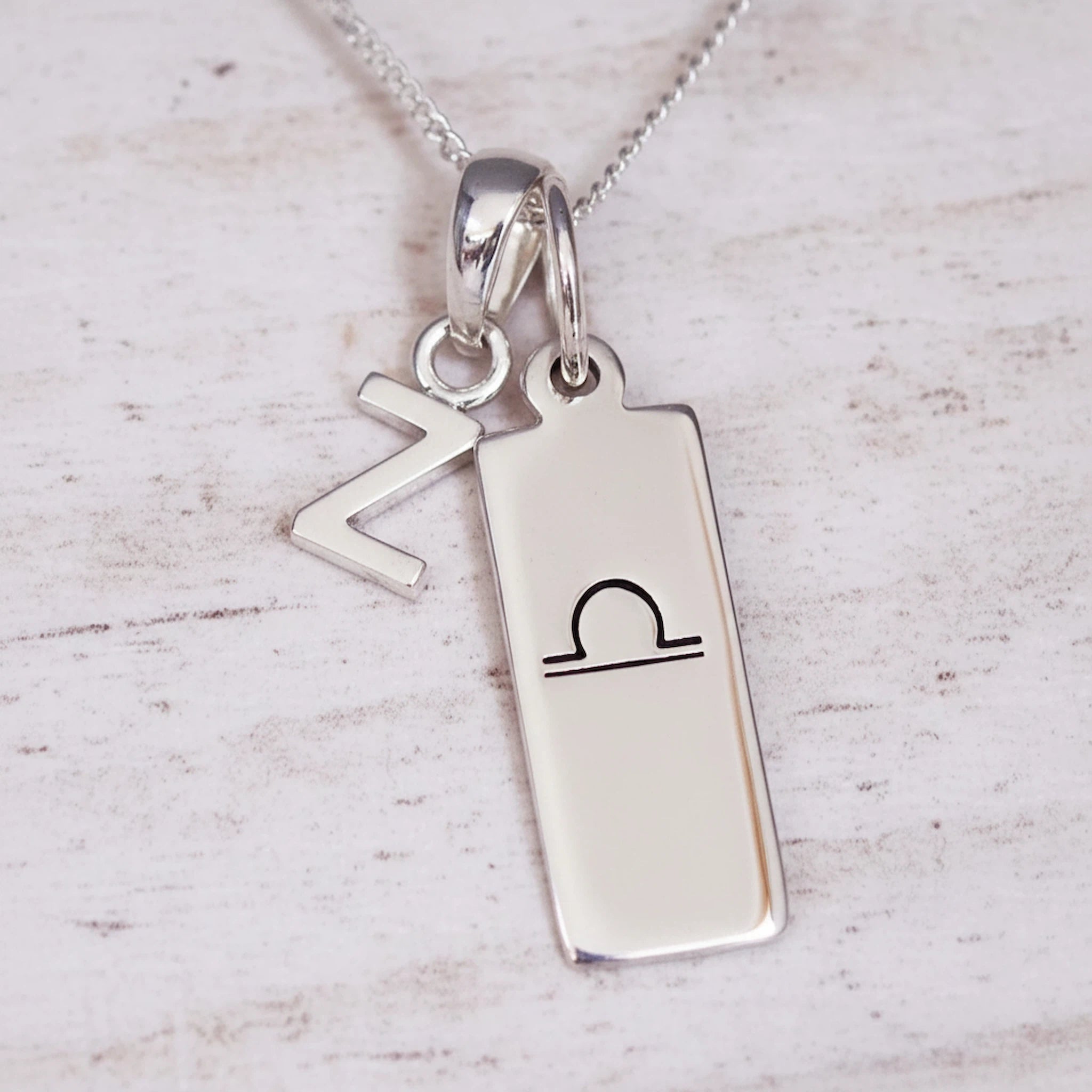 sterling Silver necklace with a Z letter pendant and a rectangle pendant engraved with the libra zodiac glyph.