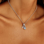 indie and harper Sterling silver initial and may birthstone aquamarine necklace being worn 