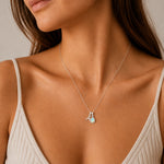 Silver initial A and October opal necklace worn at dainty scale