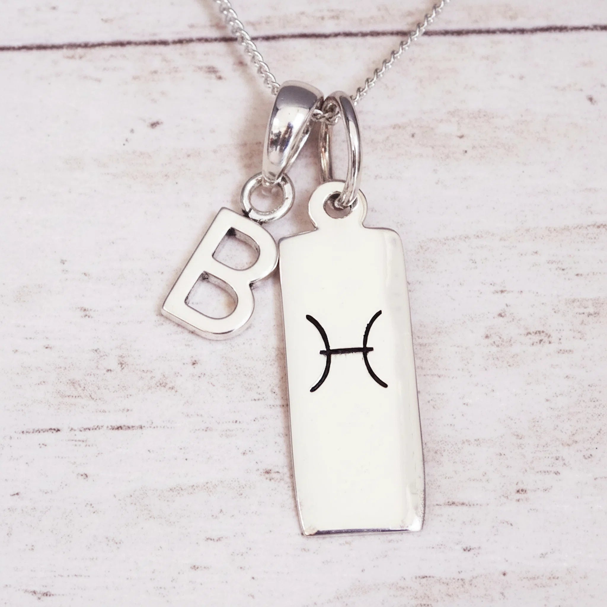 Sterling Silver Double pendant necklace with a letter B pendant and a rectangle pendant with the pisces zodiac glyph.