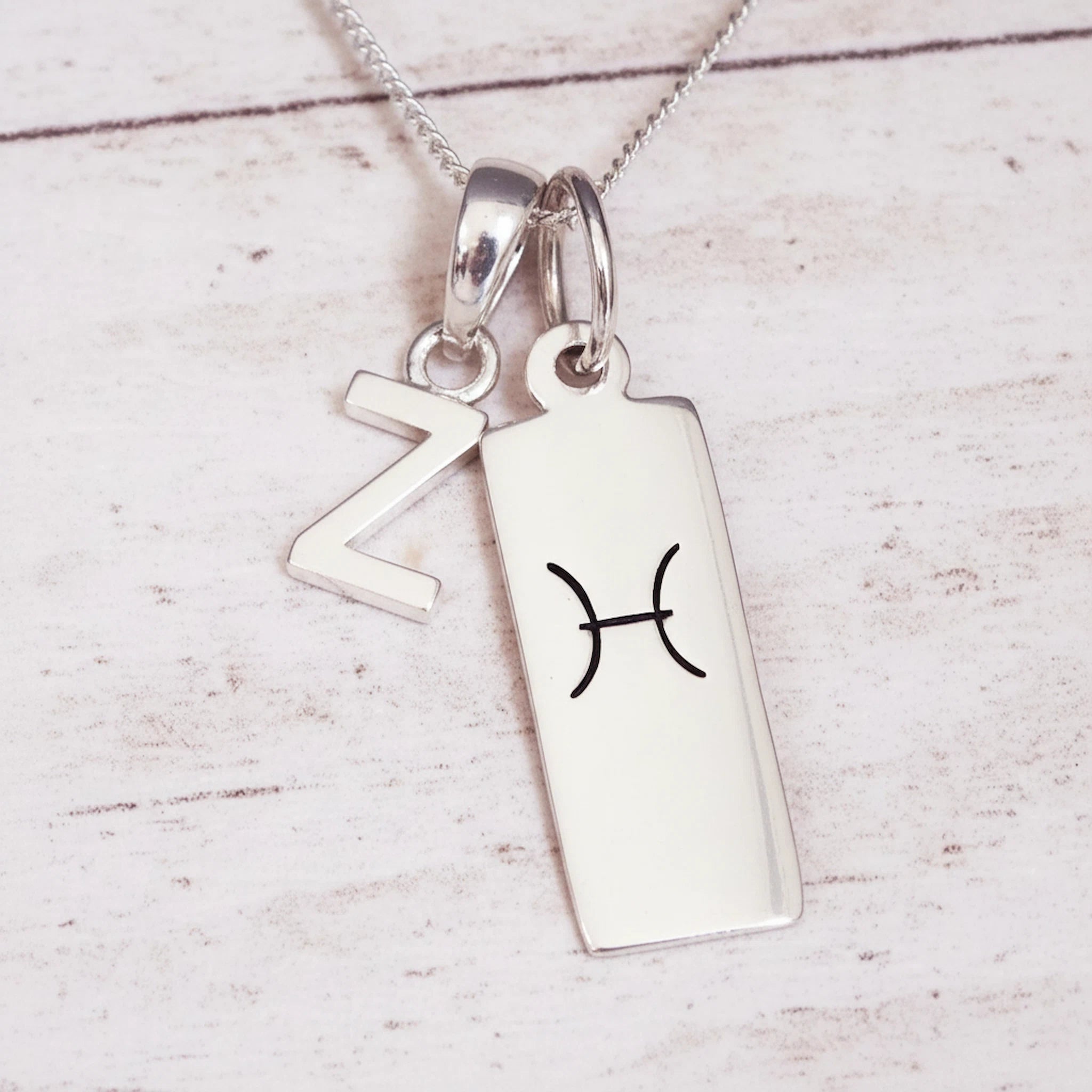 Sterling Silver Double pendant necklace with a letter Z pendant and a rectangle pendant with the pisces zodiac glyph.
