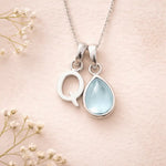 Sterling Silver March birthstone Necklace with a pear-shaped natural Aquamarine gemstone pendant and letter 'Q' charm