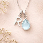Sterling Silver March birthstone Necklace with a pear-shaped natural Aquamarine gemstone pendant and letter 'R' charm