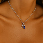 sterling silver initial and september birthstone sapphire necklace being worn - unique gifts for her australia by indie and harper