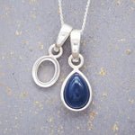 Sterling silver 'O' initial necklace with a September birthstone blue sapphire pear-shaped pendant on a grey background.