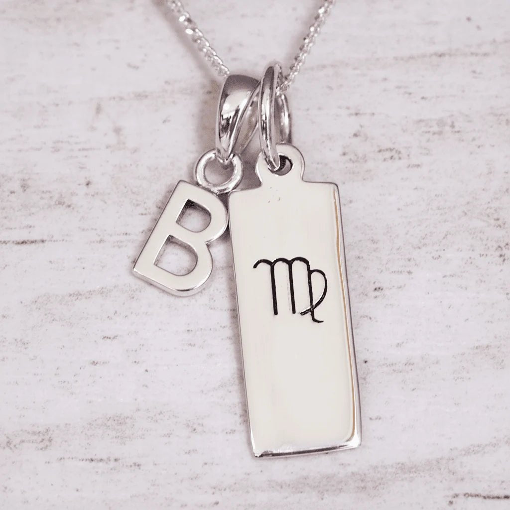 Silver ‘b’ initial pendant necklace with a pendant featuring a Virgo zodiac symbol on a light background
