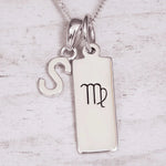 Silver ‘S’ initial pendant necklace with a pendant featuring a Virgo zodiac symbol on a light background