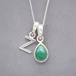 Sterling Silver double pendant necklace with a green teardrop may birthstone emerald pendant and a uppercase Z letter pendant on a grey background