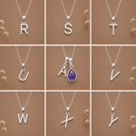 Collection of silver necklaces with initial pendant R to Y on a beige background as personalised letter options to add to a February Birthstone Amethyst Necklace.