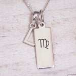 sterling silver initial l virgo zodiac star sign pendant necklace against a light wooden background