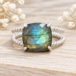 Sterling silver labradorite ring on wood with dried flowers