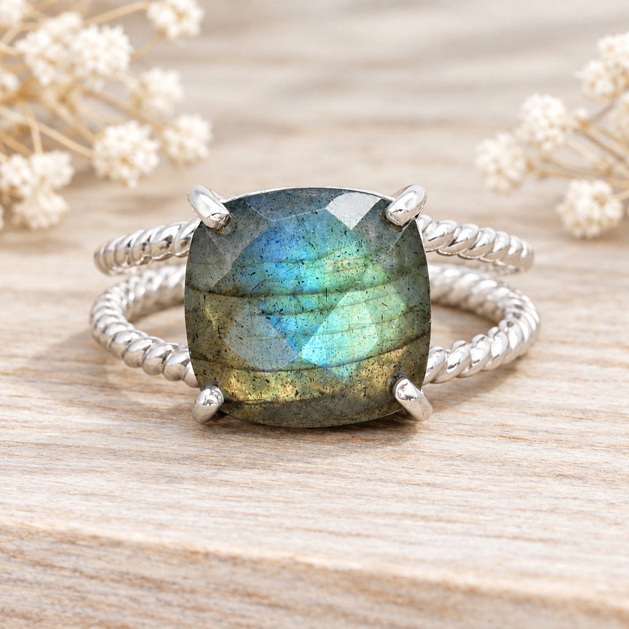 Sterling silver labradorite ring on wood with dried flowers