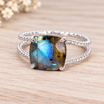 Sterling silver natural labradorite ring on a wooden surface