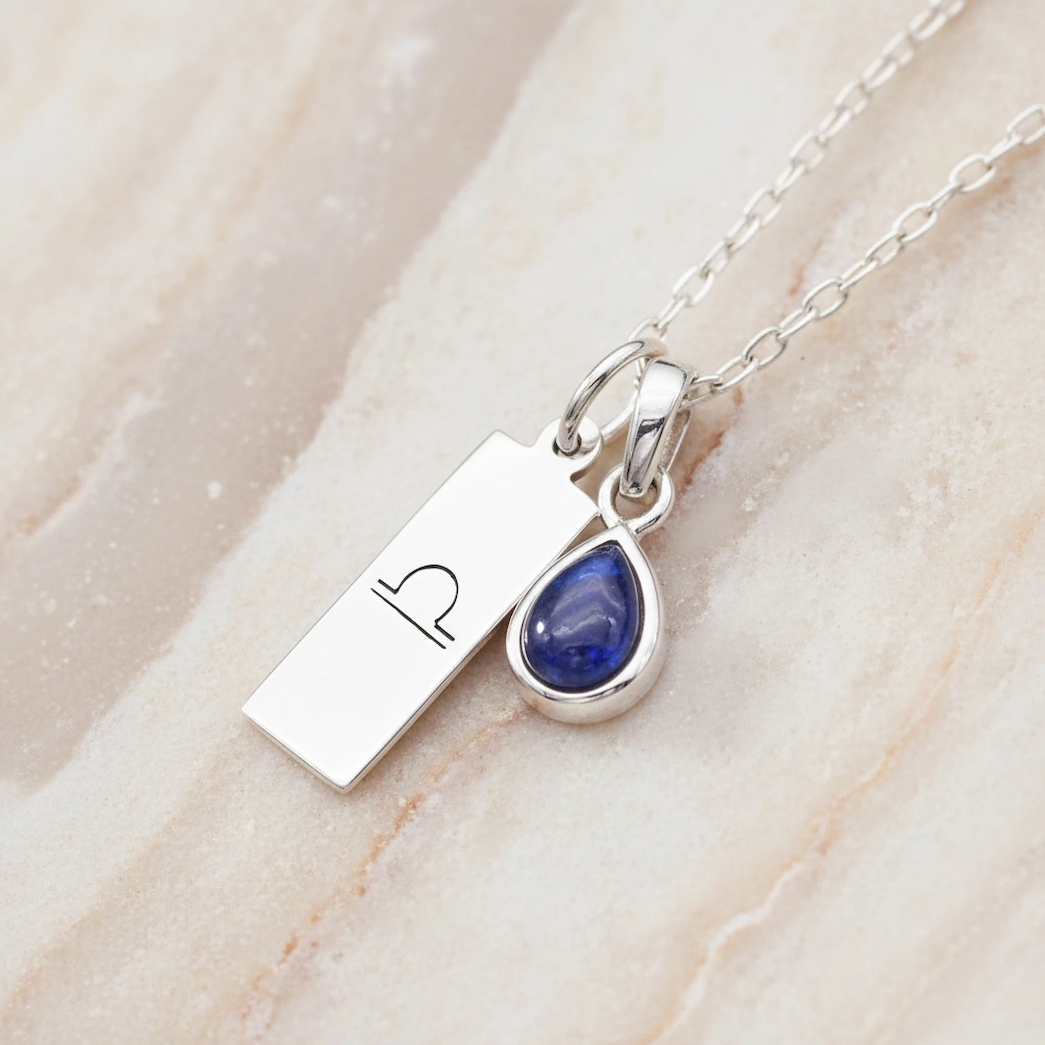 Sterling silver Libra Zodiac necklace with a September birthstone natural sapphire gemstone pendant