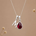 Sterling silver initial M necklace with a natural January garnet