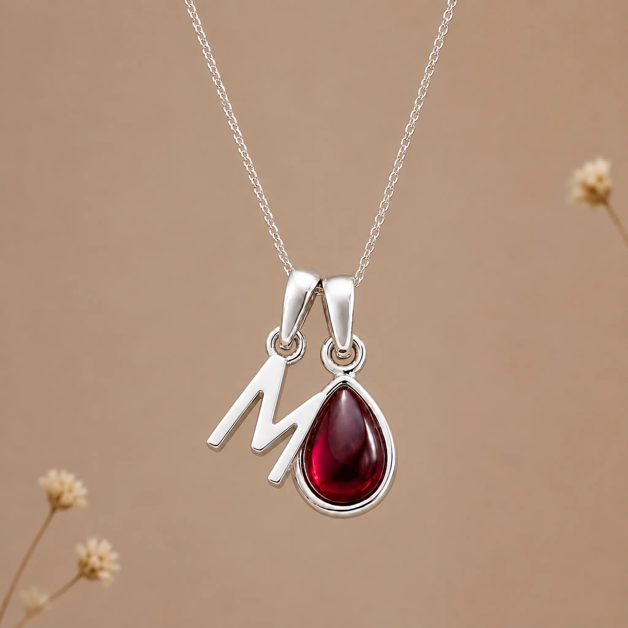 Sterling silver initial M necklace with a natural January garnet