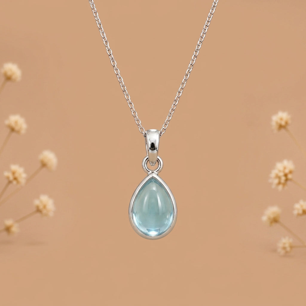 Sterling silver March birthstone necklace with a pear-shaped bezel-set aquamarine pendant