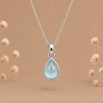 sterling silver march birthstone necklace featuring a pear-shaped bezel set cabochon natural aquamarine pendant