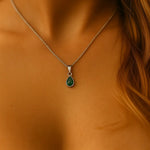 sterling silver may birthstone emerald necklace being worn - indie and harper australia