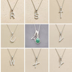Collage of silver necklaces with letters R to Y on a beige background, as personalised initial pendant options to add to a May Birthstone Emerald Necklace.