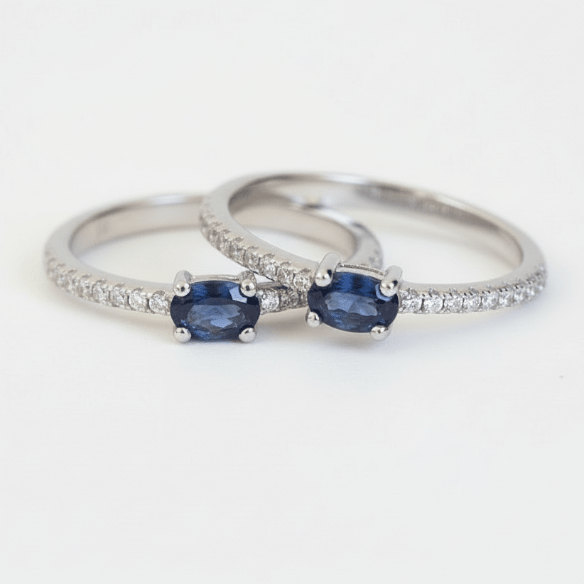 Two silver rings with blue gemstones on a white background