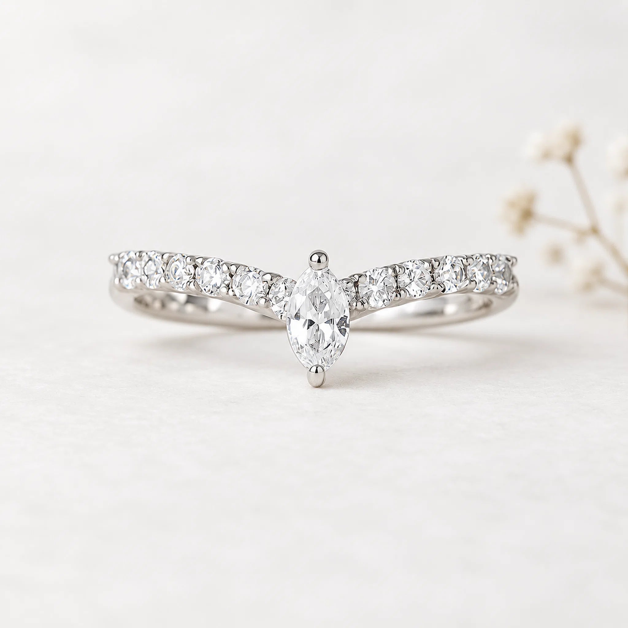 sterling silver chevron ring with cubic zirconias on a light background