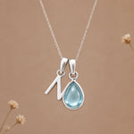 Sterling silver N initial necklace with pale blue March aquamarine in a polished teardrop bezel
