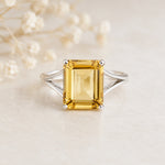 Sterling Silver Statement Style Ring wtih large emerald-cut claw set natural citrine on a light background