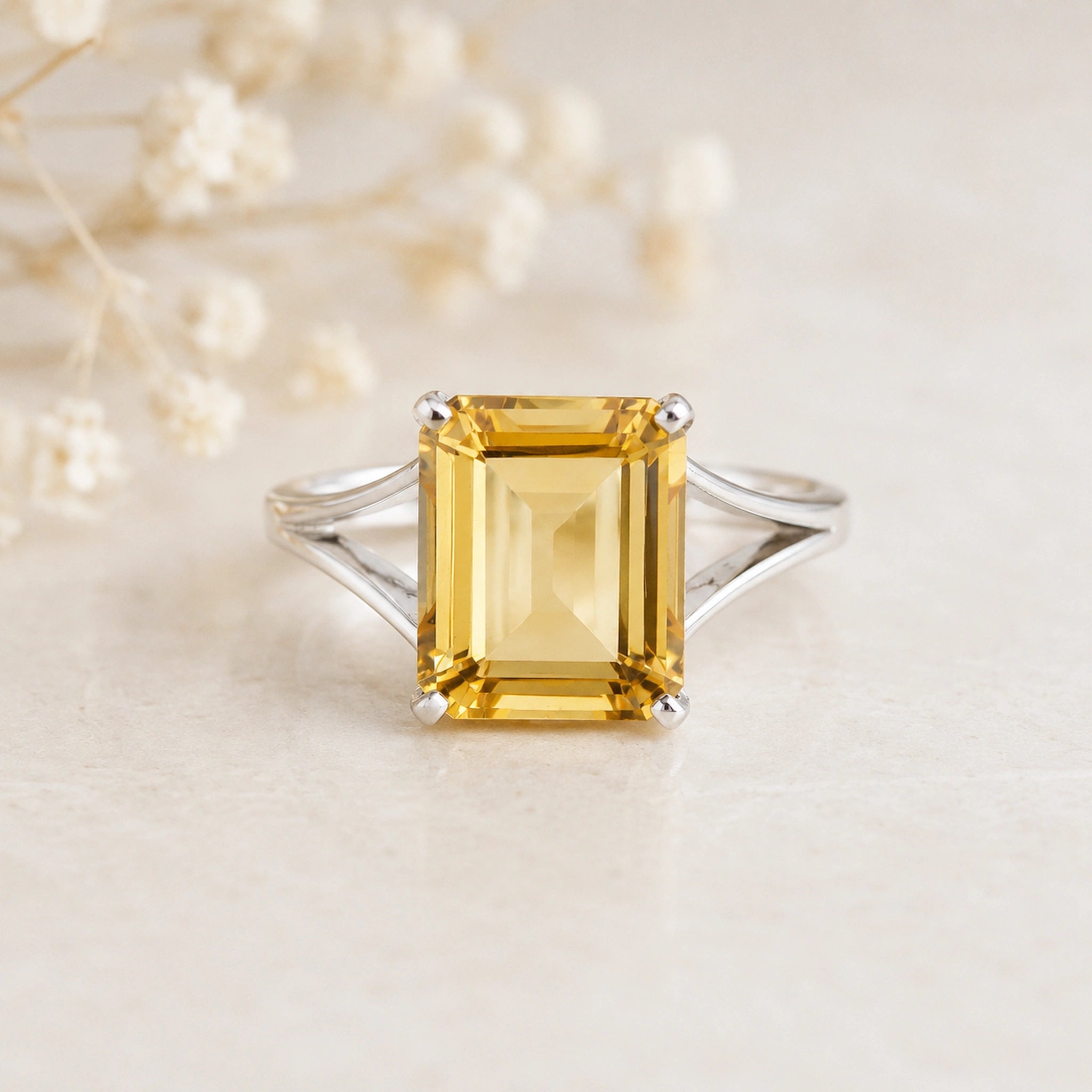 Sterling Silver Statement Style Ring wtih large emerald-cut claw set natural citrine on a light background