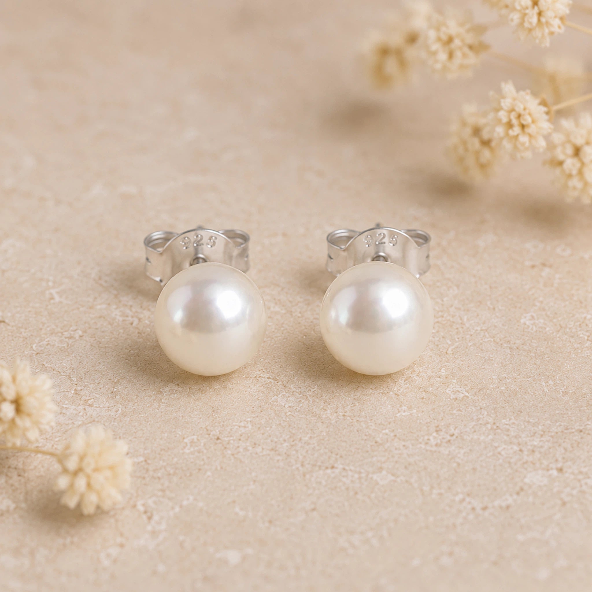 Sterling Silver Classic 7mm Natural Freshwater Pearl Earrings on a light background.