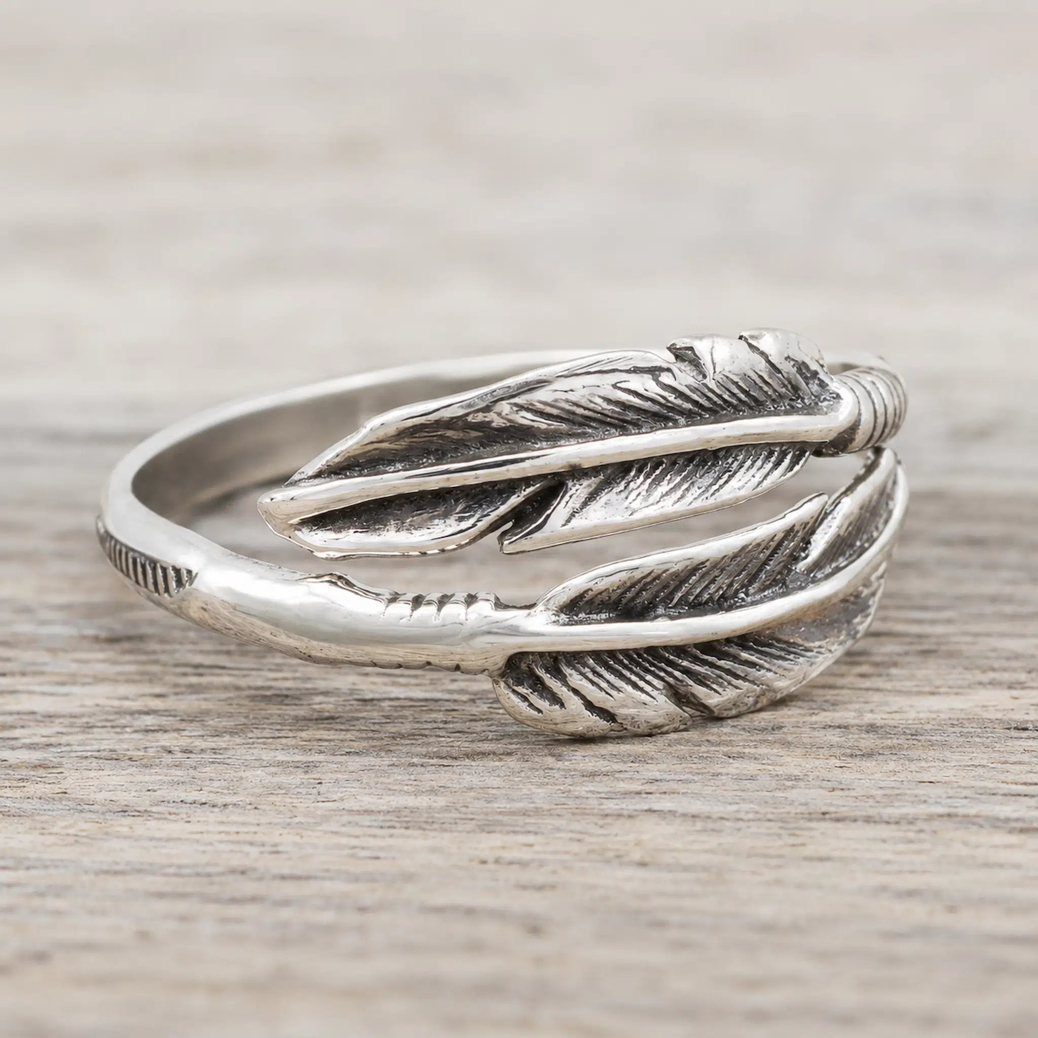 Authentic Navajo 925 sterling silver double feather wrap ring with oxidised carved detail and open adjustable band, side view