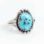 Turquoise ring with silver band on a white background