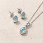 Sterling Silver November Birthstone Jewellery Set including pear-shaped natural blue topaz stud earrings and pendant necklace