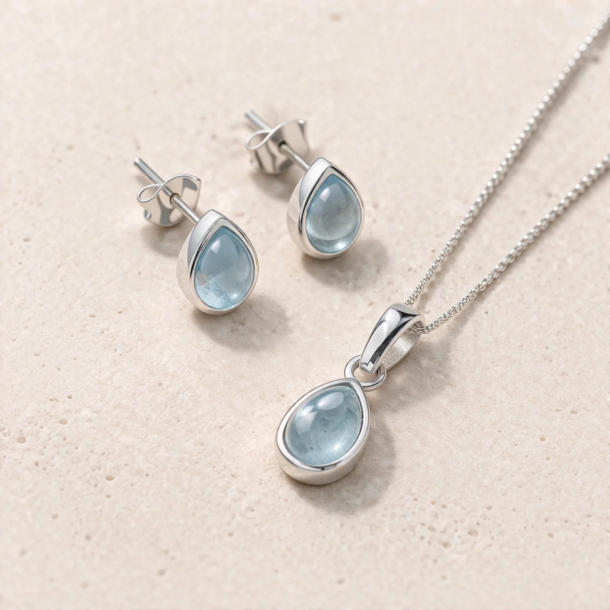 Sterling Silver November Birthstone Jewellery Set including pear-shaped natural blue topaz stud earrings and pendant necklace