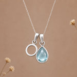 Sterling silver O initial necklace with pale blue March aquamarine in a polished teardrop bezel