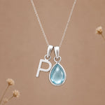 Sterling silver P initial necklace with pale blue March aquamarine in a polished teardrop bezel