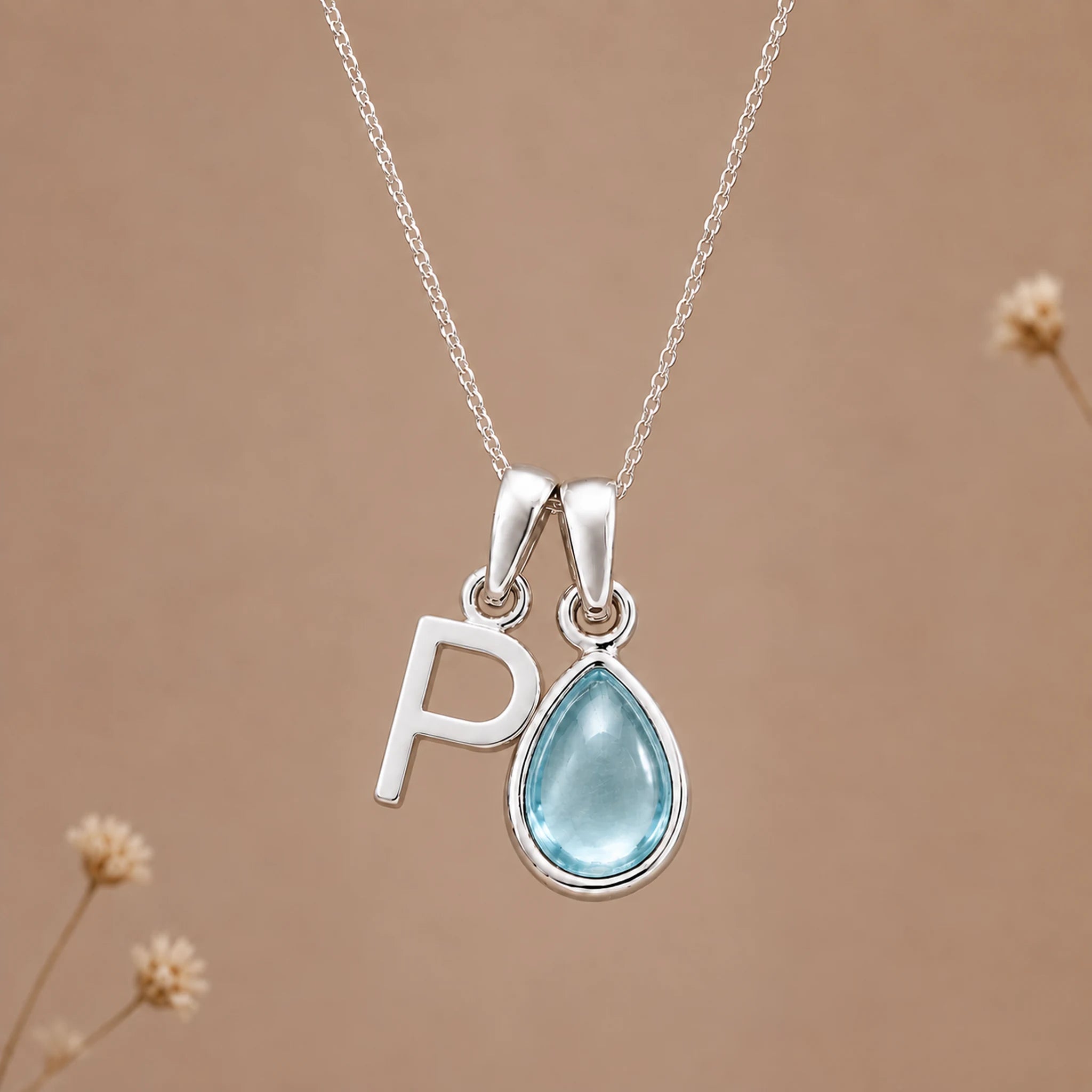 Sterling silver P initial necklace with pale blue March aquamarine in a polished teardrop bezel