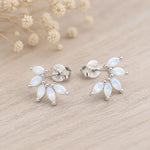 pair of sterling silver stud earrings with marquise shaped czs on a light surface