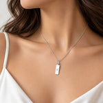 model wearing a silver pisces necklace featuring rectangle pendant engraved with a minimalist pisces zodiac star sign line glyph symbol 