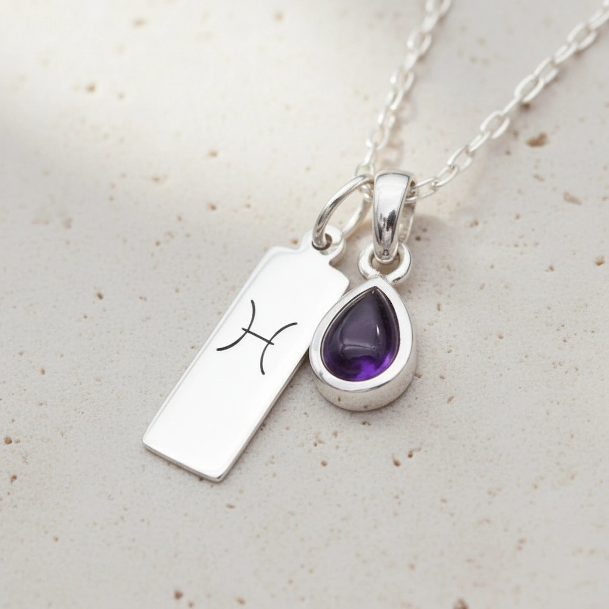 Sterling Silver February Birthstone Necklace with a pear-shaped natural Amethyst gemstone pendant and Pisces Zodiac pendant