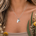 Sterling Silver necklace with pisces zodiac and march birthstone aquamarine pendants worn by a person