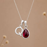 Sterling silver initial Q necklace with a natural January garnet