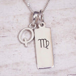 sterling silver initial q virgo zodiac star sign pendant necklace against a light wooden background