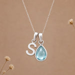 Sterling silver S initial necklace with pale blue March aquamarine in a polished teardrop bezel