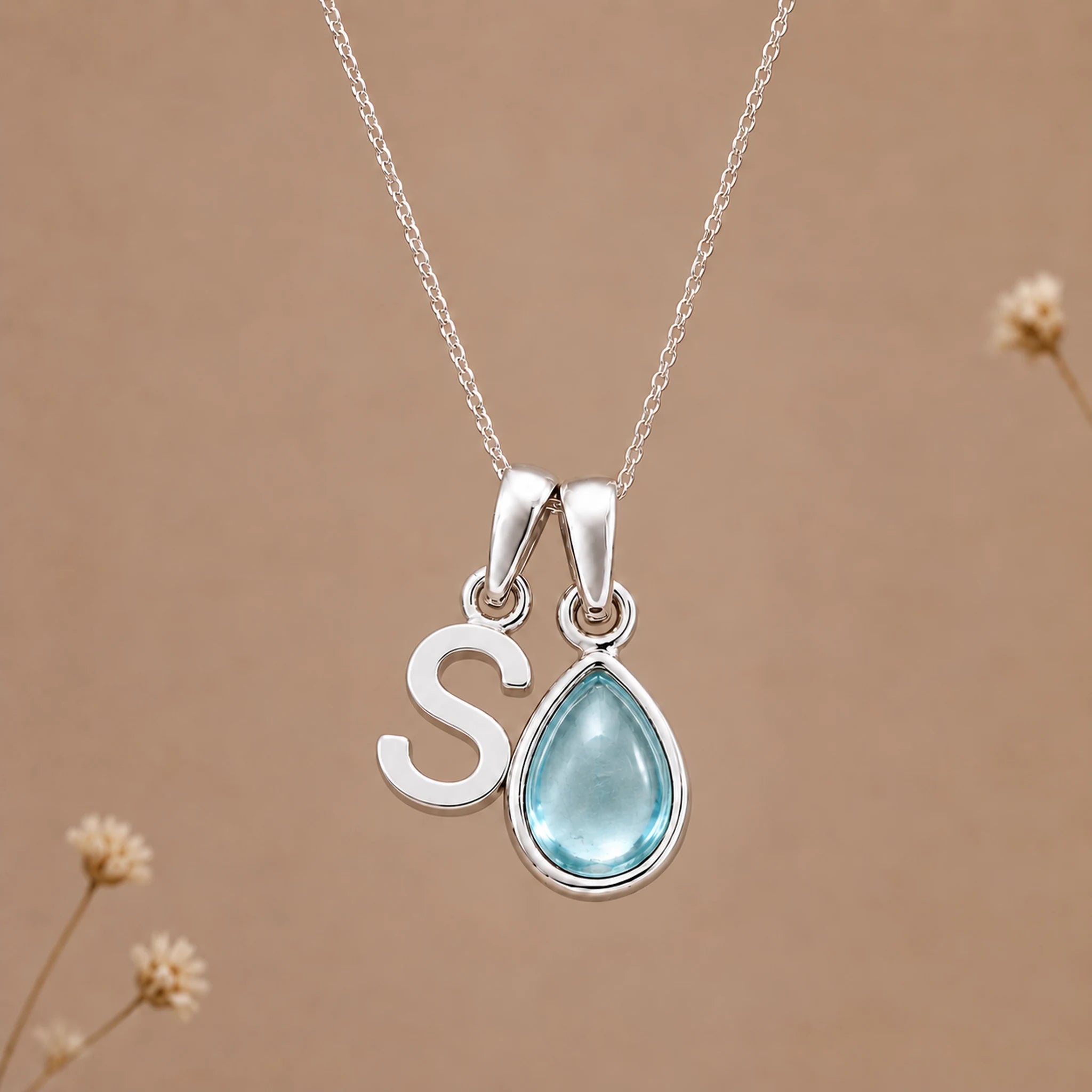 Sterling silver S initial necklace with pale blue March aquamarine in a polished teardrop bezel
